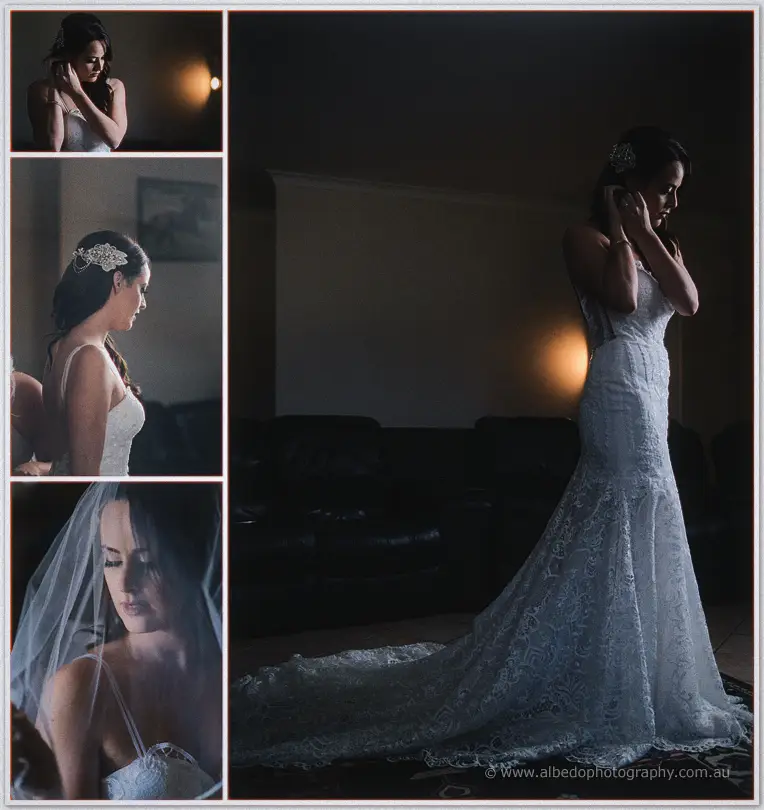 Prue fastening her earring in a long lace gown beside soft lamp light before the ceremony