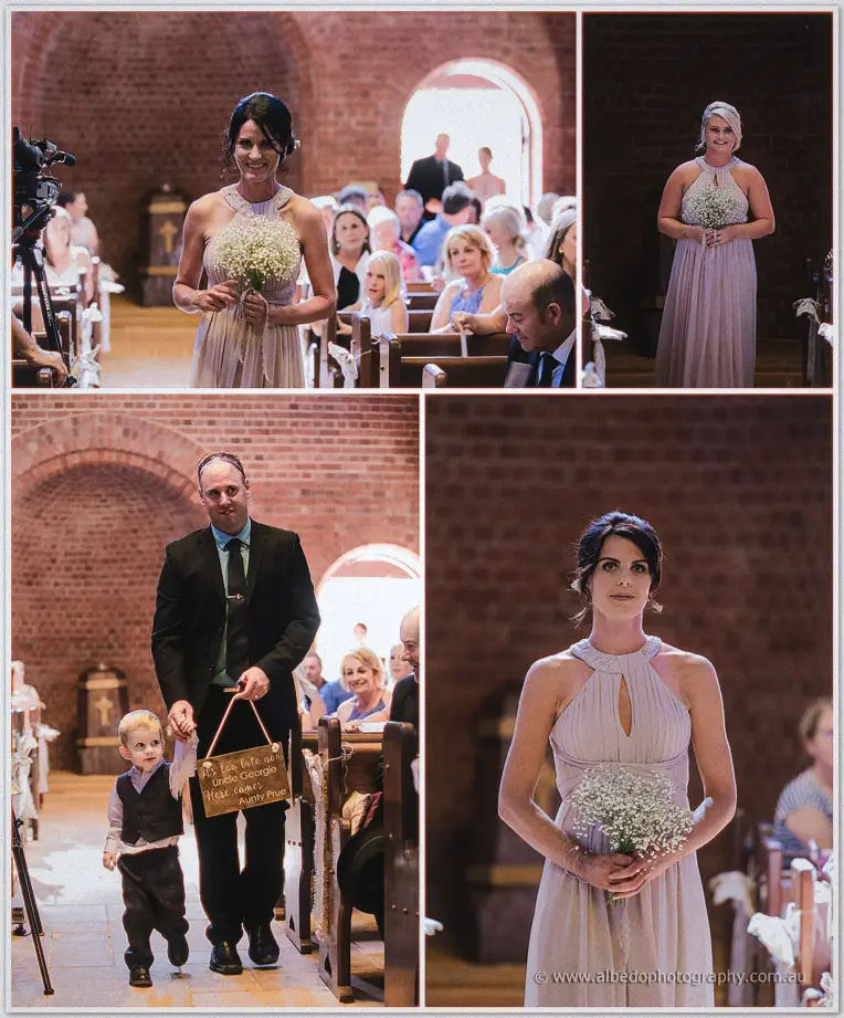 Bridesmaids and page boy walking the chapel aisle with a wooden sign for Uncle George