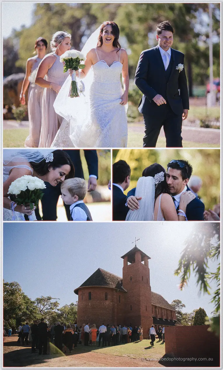 Prue and Michael laughing as they walk from the chapel with bridesmaids and guests behind