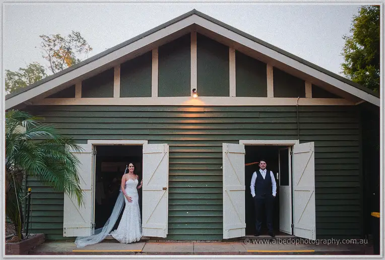 Prue and Michael at dusk in the twin doorways of the green Fairbridge hall