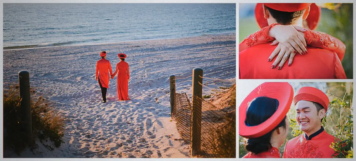 Natalie and Andrew walk hand in hand towards the sea across the sand in matching red