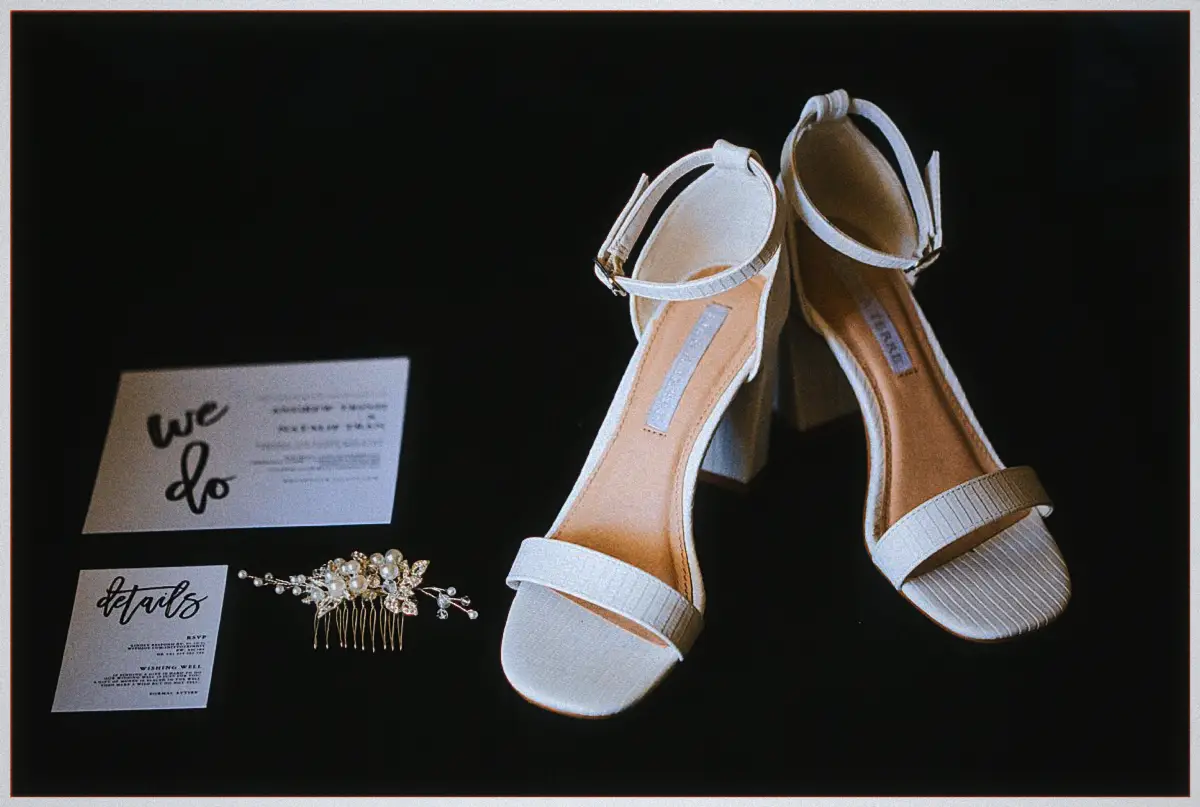 Natalie's white block-heel sandals with her we do invitations and pearl hair comb on black