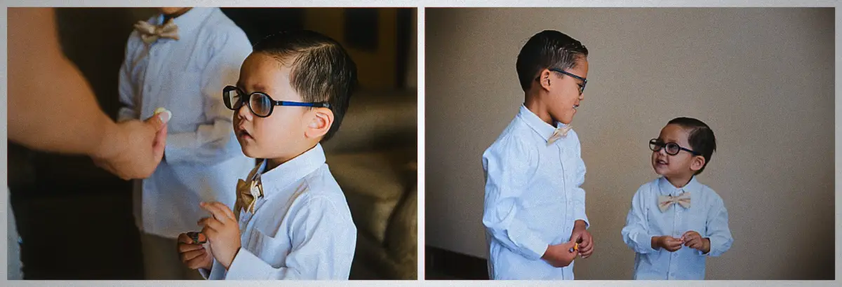 Two little page boys in white shirts and bow ties fidget and grin in the suite