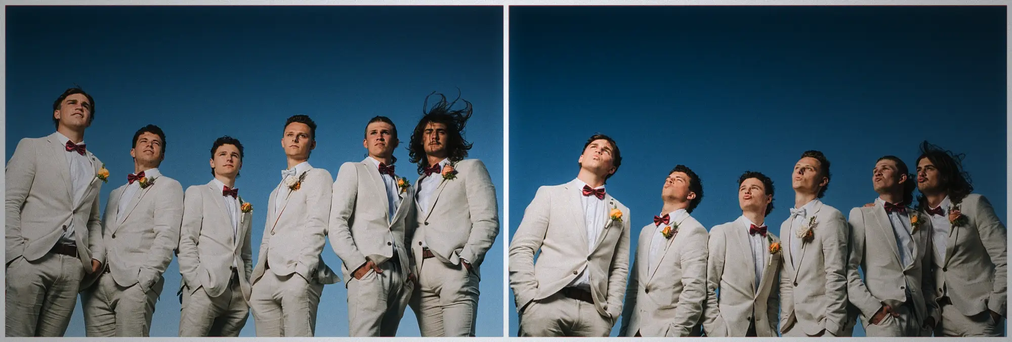 Six groomsmen in cream suits and bow ties photographed from below against a deep blue sky.